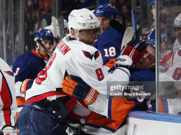 Alex Ovechkin of the Washington Capitals takes a two minute roughing penalty against Casey Cizikas of the New York Islanders at the Nassau Veterans...