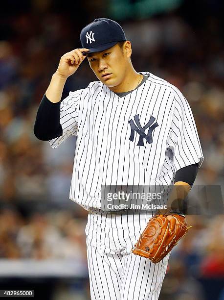 Masahiro Tanaka of the New York Yankees walks to the dugout after the fifth inning against the Boston Red Sox at Yankee Stadium on August 4, 2015 in...