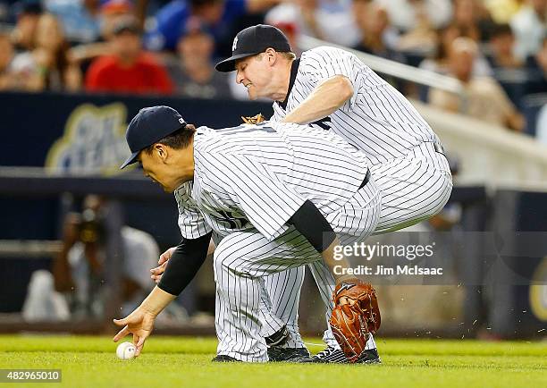 Masahiro Tanaka and Chase Headley of the New York Yankees collide as both try to field a fifth inning bunt from Alejandro De Aza of the Boston Red...