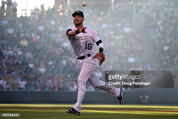 First baseman Kyle Parker of the Colorado Rockies earns an assist as he fields a ground ball by Vidal Nuno of the Seattle Mariners and tosses it to...