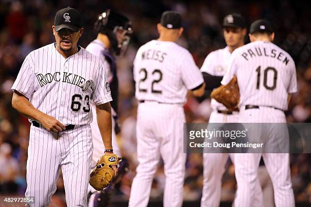 Relief pitcher Rafael Betancourt of the Colorado Rockies heads for the dugout after being removed from the game against the Seattle Mariners by...