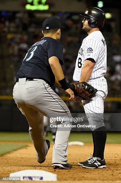 Jesus Montero of the Seattle Mariners tags out Michael McKenry of the Colorado Rockies, who stood still upon being picked off by Joe Beimel during an...