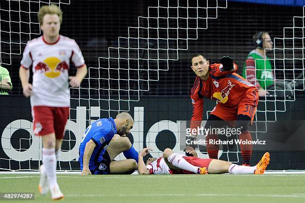 Luis Robles of the New York RedBulls calls for help from the bench for fallen teammate Kosuke Kimura during the MLS game against the Montreal Impact...