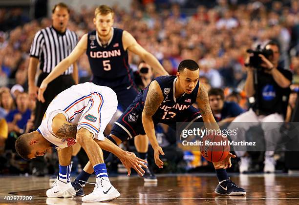 Shabazz Napier of the Connecticut Huskies picks up the ball from Scottie Wilbekin of the Florida Gators during the NCAA Men's Final Four Semifinal at...