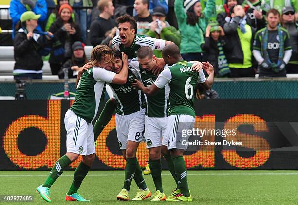 Portland Timbers teammates mob Diego Valeri of Portland Timbers after Valeri scored a goal during the first half of the game against the Seattle...