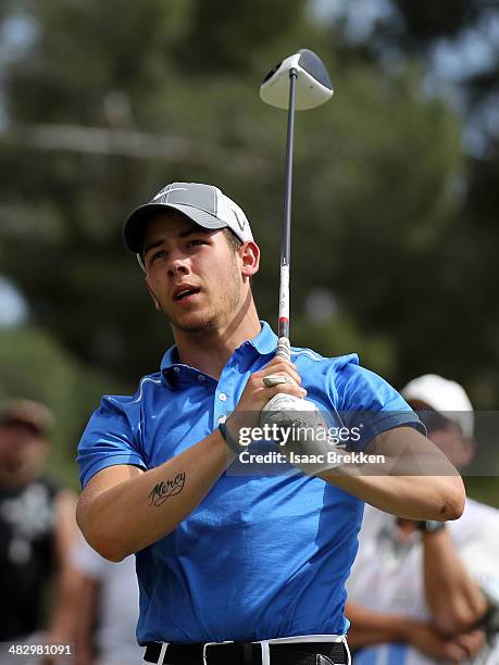 Singer Nick Jonas hits a tee shot during Aria Resort & Casino's 13th Annual Michael Jordan Celebrity Invitational at Shadow Creek on April 5, 2014 in...