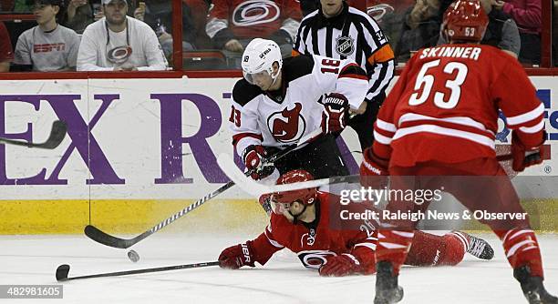 The Carolina Hurricanes' John-Michael Liles and Jeff Skinner defend the New Jersey Devils' Steve Bernier during the second period at PNC Arena in...