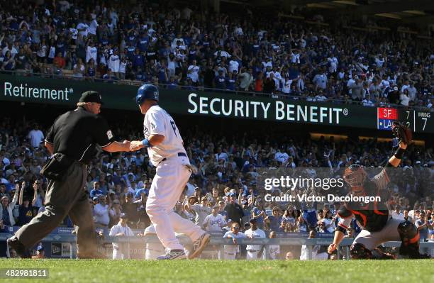 Home plate umpire Joe West calls A.J. Ellis of the Los Angeles Dodgers out at the plate as catcher Buster Posey of the San Francisco Giants holds up...