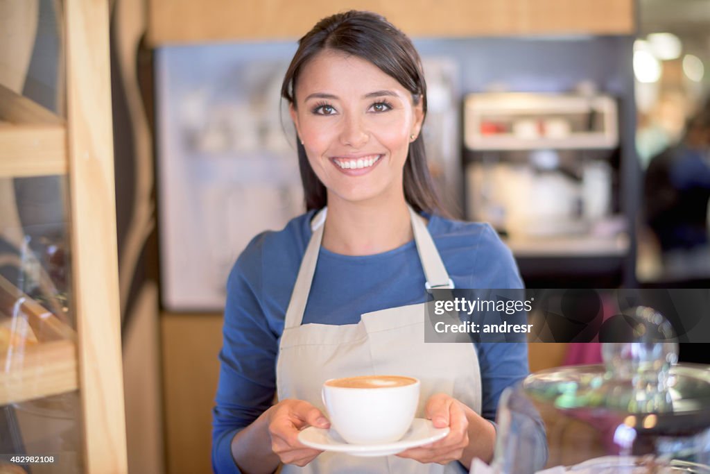 Woman serving coffee at a cafe