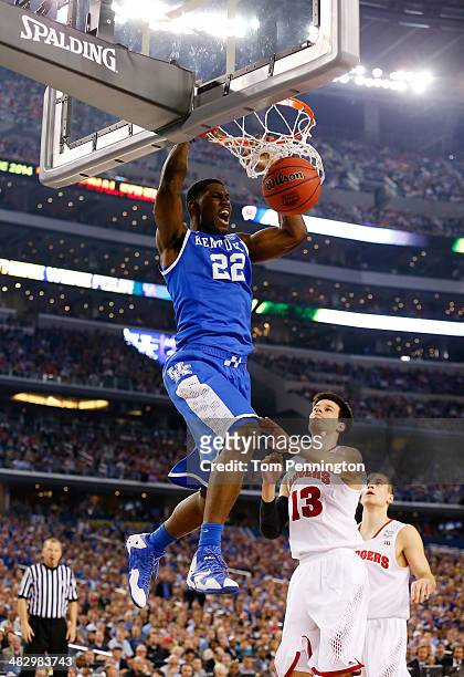 Alex Poythress of the Kentucky Wildcats dunks as Duje Dukan of the Wisconsin Badgers defends during the NCAA Men's Final Four Semifinal at AT&T...