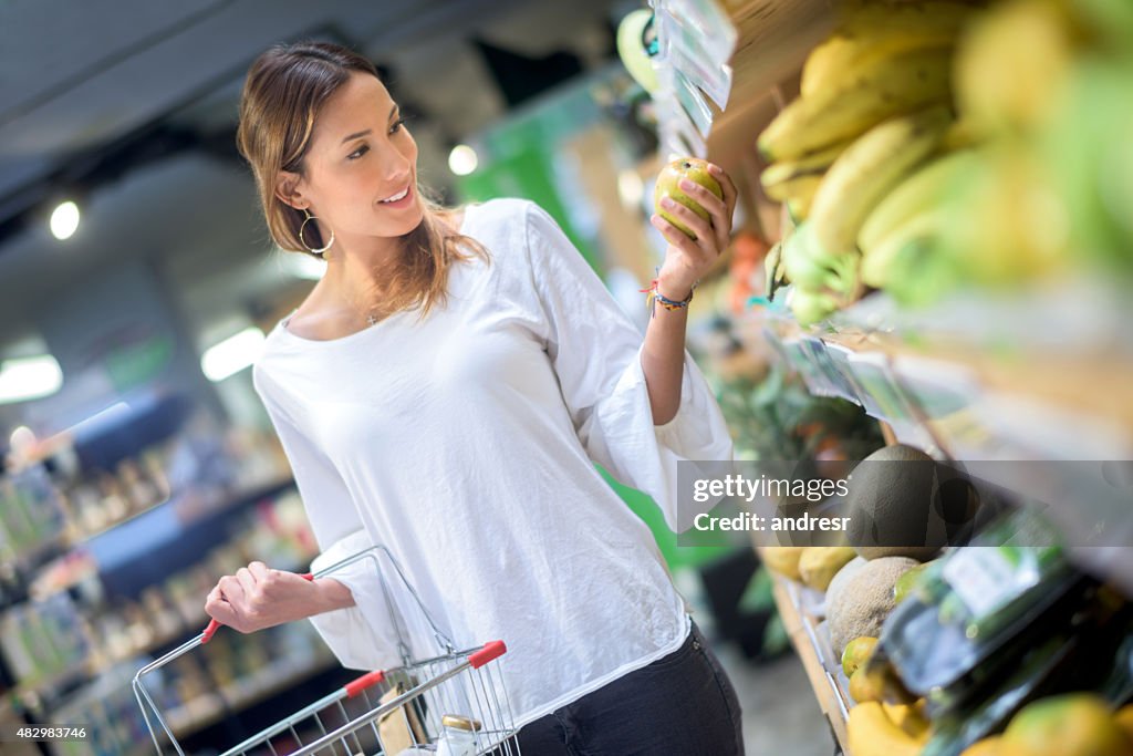 Asian woman grocery shopping at the supermarket