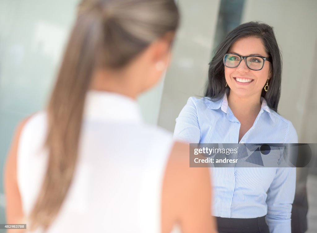 Business woman greeting with a handshake