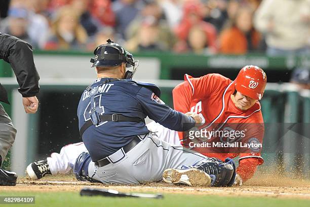 Ryan Doumit of the Atlanta Braves tags out Jose Lobaton of the Washington Nationals at home plate in the fifth inning on April 5, 2014 at Nationals...