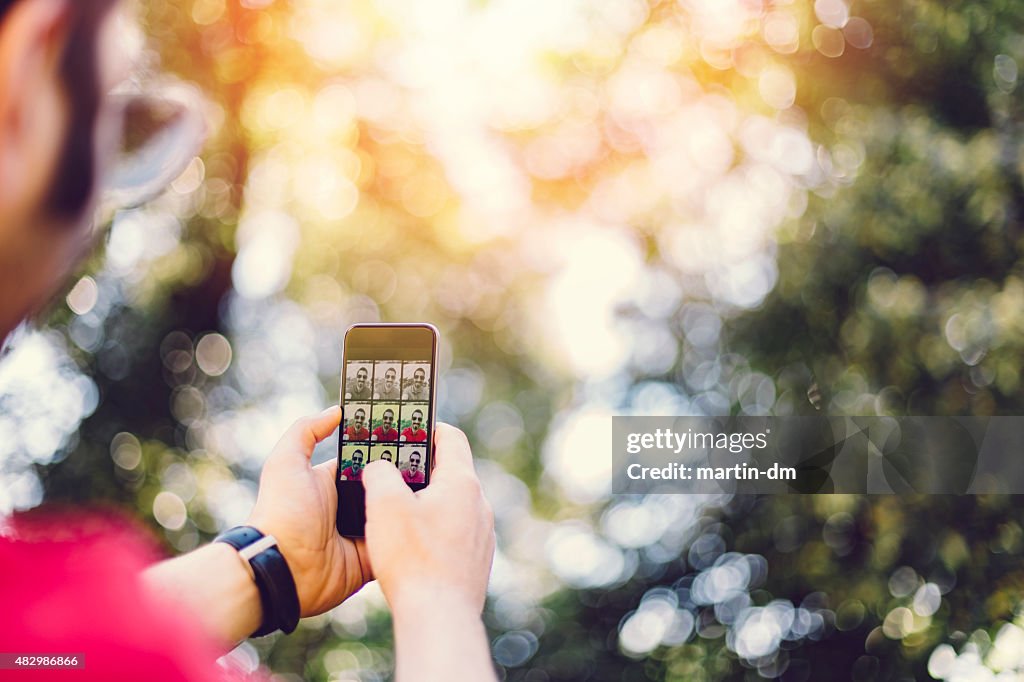 Guy taking a selfie with smartphone