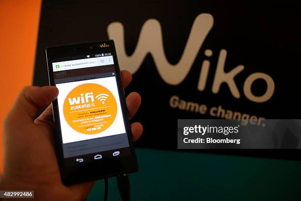 Free wifi logo sits on a Wiko SAS smartphone in this arranged photo taken inside a Euskaltel SA phone store in Barakaldo, Spain, on Tuesday, Aug. 4.,...