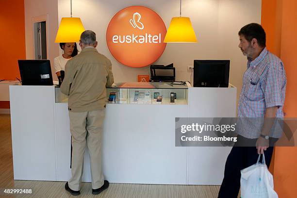 Customer stands at the service counter inside a Euskaltel SA phone store in Barakaldo, Spain, on Tuesday, Aug. 4., 2015. Euskaltel, the phone and...