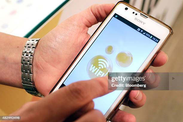 An employee demonstrates the wifi function on a Sony Mobile Communications Inc. Smartphone inside a Euskaltel SA phone store in Bilbao, Spain, on...