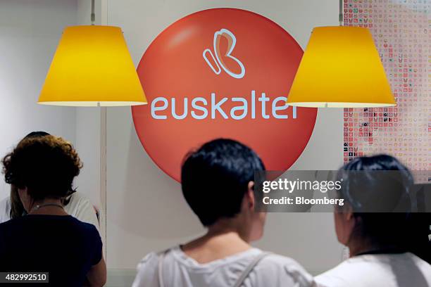 Customers stand at a service desk inside a Euskaltel SA phone store in Barakaldo, Spain, on Tuesday, Aug. 4., 2015. Euskaltel, the phone and...