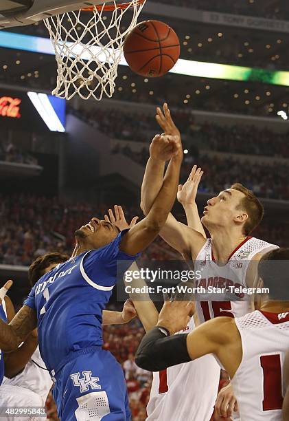 Kentucky Wildcats guard/forward James Young puts up a shot defended by Wisconsin Badgers forward Sam Dekker during the second half as the Kentucky...