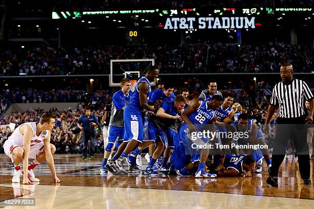 The Kentucky Wildcats celebrate after defeating the Wisconsin Badgers 74-73 in the NCAA Men's Final Four Semifinal at AT&T Stadium on April 5, 2014...