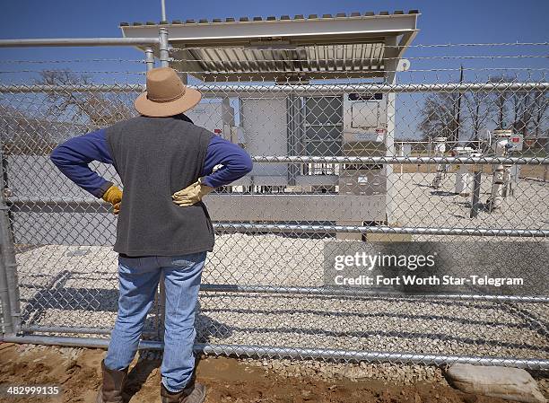 Julia Trigg Crawford looks at the TransCanada Keystone XL pipeline valve station just south of her land in Direct, TX, Sunday, March 23, 2014.