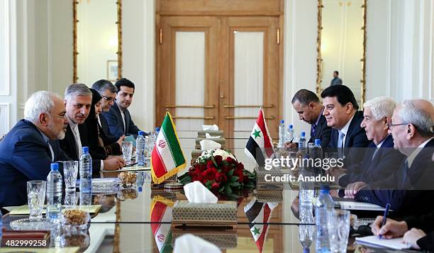 Iranian Foreign Minister Mohammad Javad Zarif and Syrian Foreign Minister Walid Muallem hold a meeting in the foreign ministry building in Tehran,...