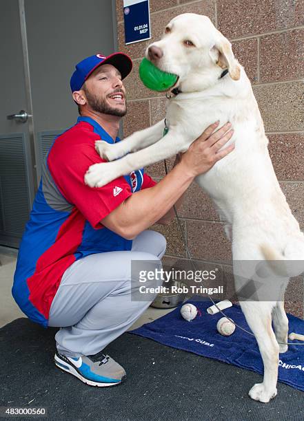 George Kottaras of the Chicago Cubs plays with his dog Leo during a Spring Training workout on Tuesday, February 25, 2014 at Cubs Park in Mesa,...