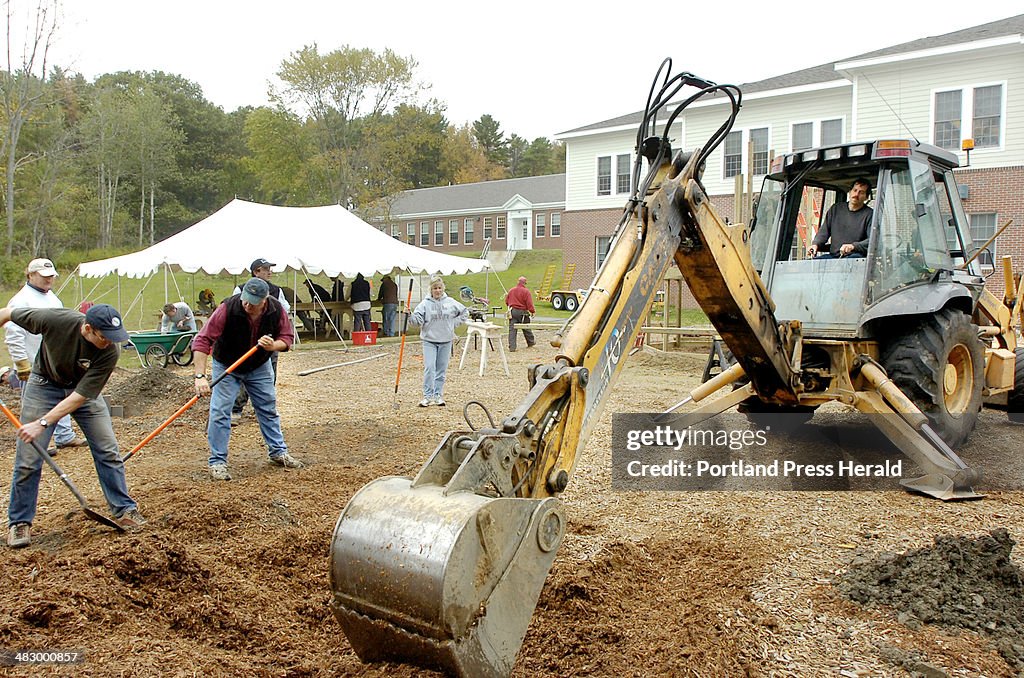 Volunteer workers along with a crew from Learning Structures, from Stratford, New Hampshire, are bui