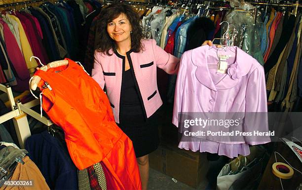 Staff Photo by Doug Jones, Monday, April 3, 2006: Diane Skog with a couple of the hundreds of outfits that will be offered for sale at the fifth...