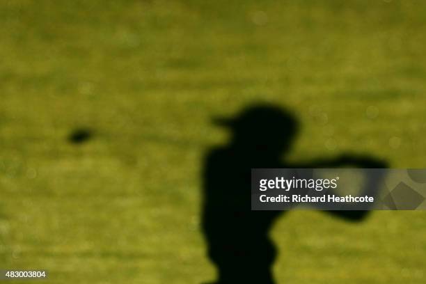 The shadow of a golfer as he hits a shot during a practice round for the World Golf Championship - Bridgestone Invitational at Firestone Coutry Club...