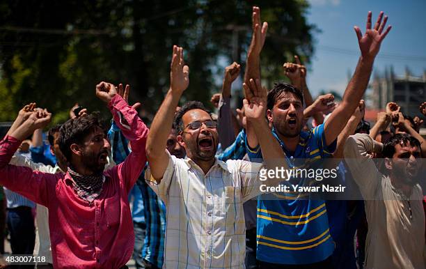 Kashmiri government teachers shout anti-government slogans during a protest against government's decision to hold a screening test for government...