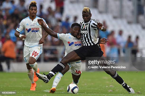 Paul Pogba of Juventus FC competes with Brice Djadjedje of Olympique de Marseille during the preseason friendly match between Olympique de Marseille...