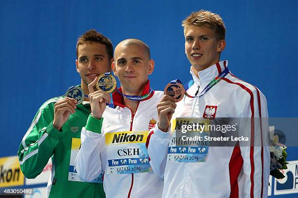 Silver medallist Chad Le Clos of South Africa, gold medallist Laszlo Cseh of Hungary and bronze medallist Jan Switkowski of Poland pose during the...