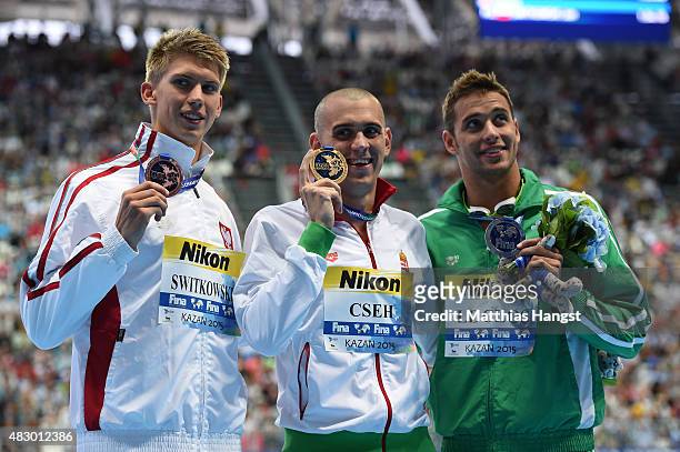 Silver medallist Chad Le Clos of South Africa, gold medallist Laszlo Cseh of Hungary and bronze medallist Jan Switkowski of Poland pose during the...