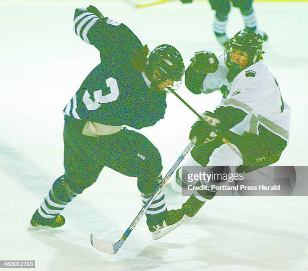 Staff Photo by Herb Swanson, Sunday, March 7, 2004: Middlebury's Shannon Tarrant collides with Bowdoin's Kelsey Wilcox during first period action in...