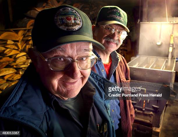 March 4, 2004 Staff Photo by Fred J. Field: -- At Grandpa Joe's Sugar House in North Baldwin, Norman McKenney foreground and his 53-year-old son...