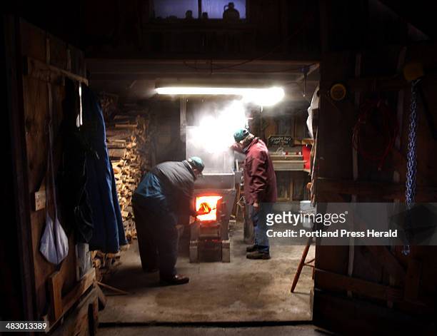 March 4, 2004 Staff Photo by Fred J. Field: -- Norman and Steven McKenney of North Baldwin work the evaporator at Grandpa Joe's Sugar House. They can...