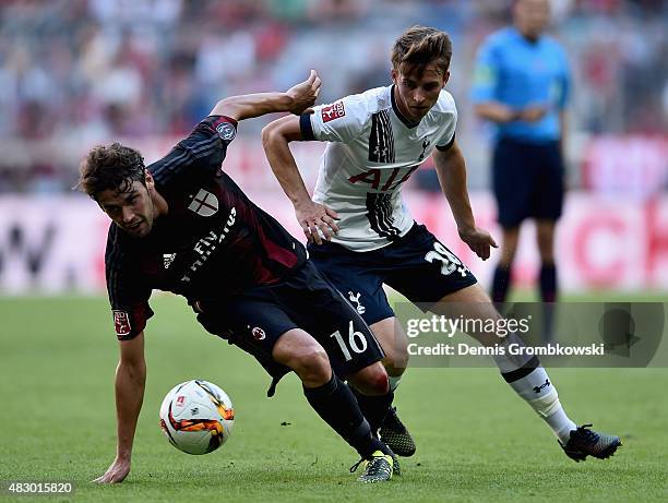 Tom Carroll of Tottenham Hotspur challenges Andrea Poli of AC Milan during the Audi Cup 2015 match between Tottenham Hotspur and AC Milan at Allianz...