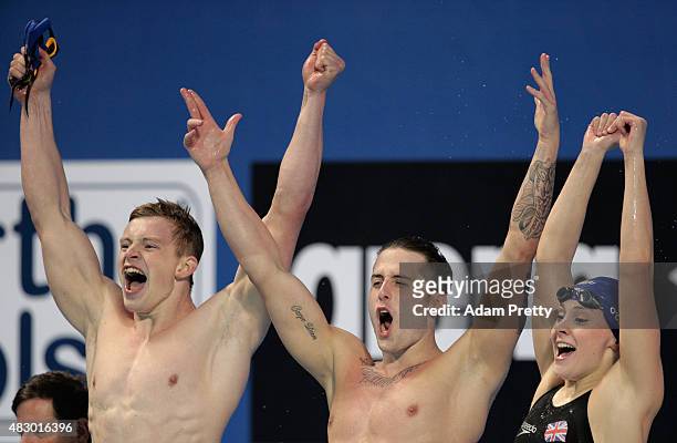Adam Peaty, Chris Walker-Hebborn and Siobhan-Marie O'Connor of Great Britain celebrate winning the gold medal in a new world record of 3:41.71 in the...