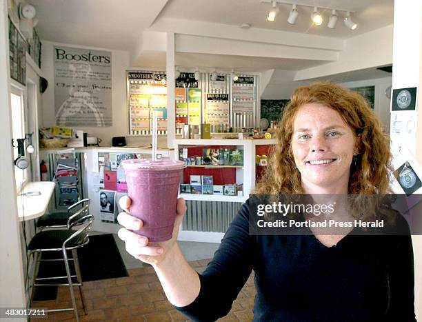 Staff Photo by John Patriquin, Wednesday, August 10, 2005: Nicole Bsullak , owner of Wicked Pulp Cafe & Juice Bar in Portland, holds one of her...