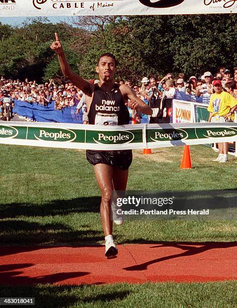 Saturday, August 7, 1999 -- Khalid Khannouchi of Morocco crosses the finish line to win the Peoples Beach to Beacon 10K race in a time of 27: 48...