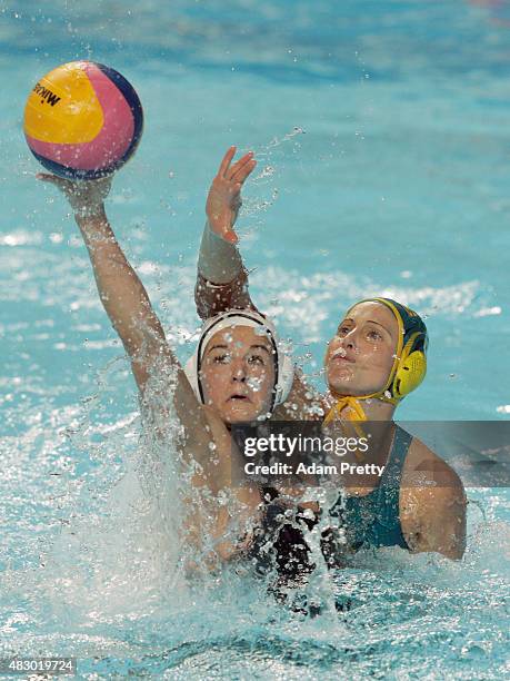 Kiley Neushul of the United States is challenged by Glennie McGhie of Australia in the Women's Semi Final between the United States and Australia on...
