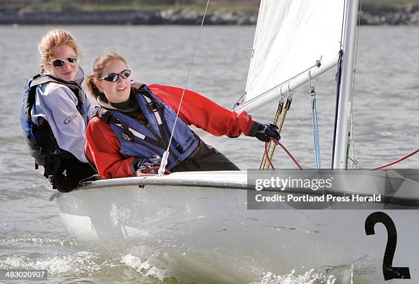 Staff photo by Gregory Rec -- Thursday, May 4, 2006 -- Kati Gullick, left, and Mae Lortie sail during a practice on Casco Bay last week.