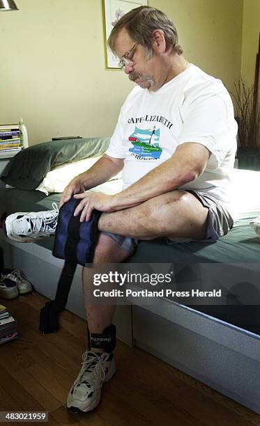 Thursday, May 5, 2005: Kevin Sweeney straps weights to his ankle before doing a series of leg raises. After having his left knee replaced last year,...