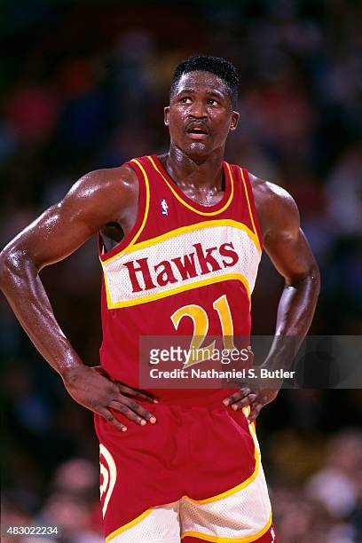 Dominique Wilkins of the Atlanta Hawks stands on the court during a game circa 1991 at The Omni in Atlanta, Georgia. NOTE TO USER: User expressly...
