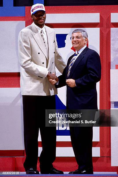 Walter McCarty of the New York Knicks shakes hands with Commissioner David Stern after being selected 19th overall during the 1996 NBA Draft in East...