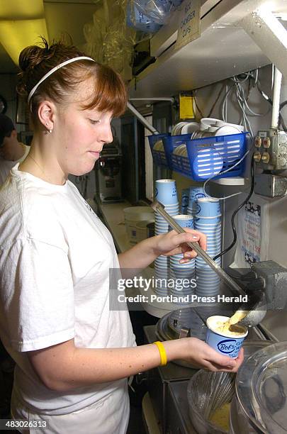 Staff Photo by John Ewing, Tuesday, July 19, 2005: Elizabeth Baker, from Eliot, prepares a cup of clam chowder while working the service window at...