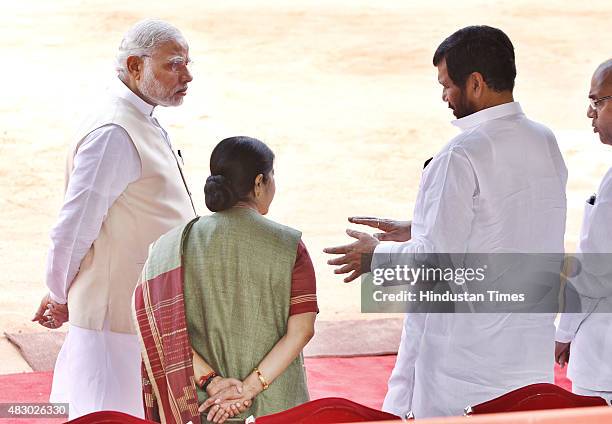 Prime Minister Narendra Modi talks with External Affairs Minister Sushma Swaraj and Food and Consumer Affairs Minister Ram Vilas Paswan prior to a...