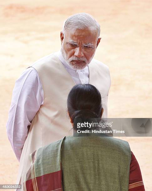 Prime Minister Narendra Modi talks with External Affairs Minister Sushma Swaraj prior to a ceremonial reception of President of the Republic of...