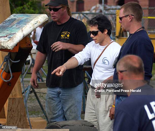 Staff Photo by Gordon Chibroski, Tuesday, July 6, 2004: Bruce Schwab gives directions to workers at Portland Yacht Services as his sailboat is put on...